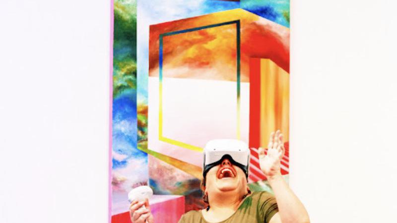 Visitor in a VR headset in front of a painted portal
